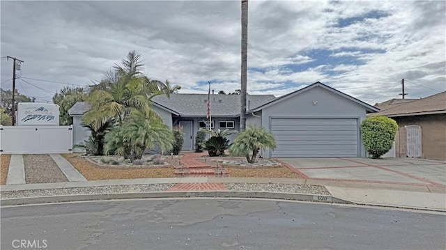 view of front of house with fence, stucco siding, a garage, driveway, and a gate