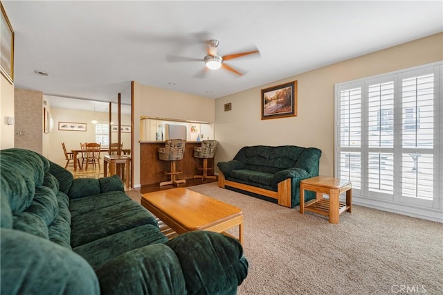 living room featuring ceiling fan and carpet flooring