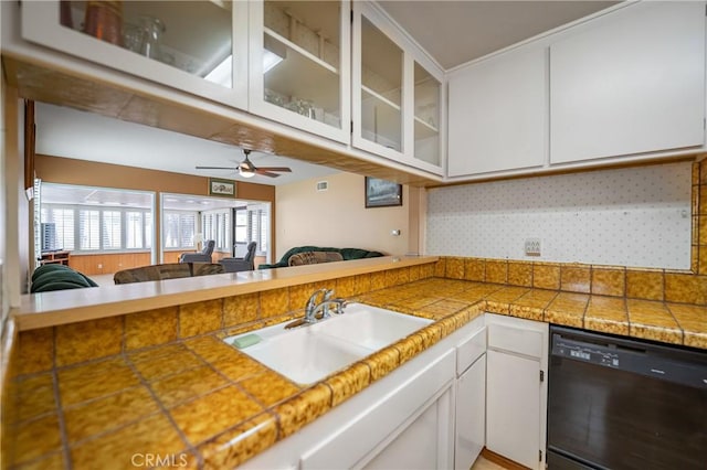 kitchen featuring white cabinets, dishwasher, glass insert cabinets, and a sink