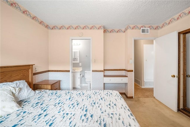 carpeted bedroom featuring visible vents and a textured ceiling