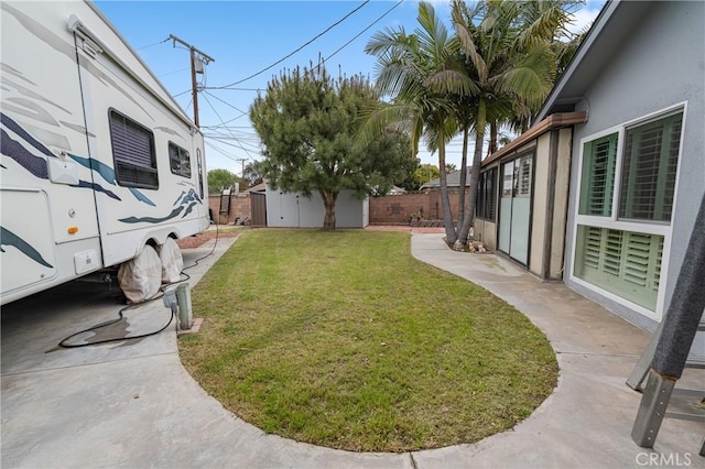 view of yard with an outbuilding and a fenced backyard