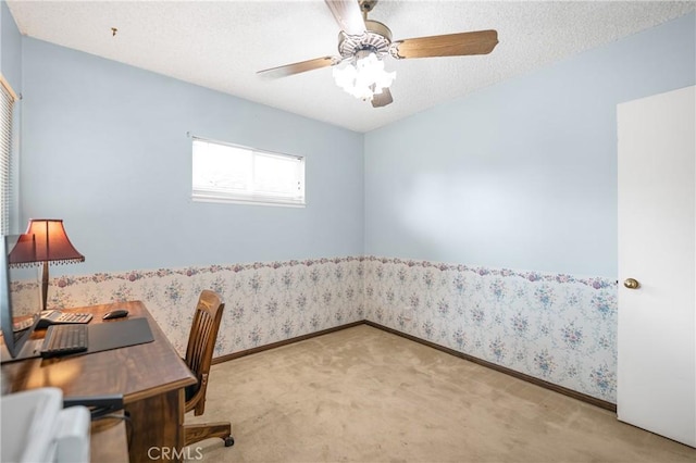 office area featuring wallpapered walls, baseboards, light colored carpet, a textured ceiling, and a ceiling fan