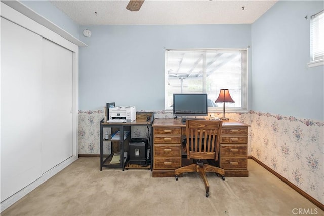 carpeted office featuring wallpapered walls, baseboards, and a textured ceiling