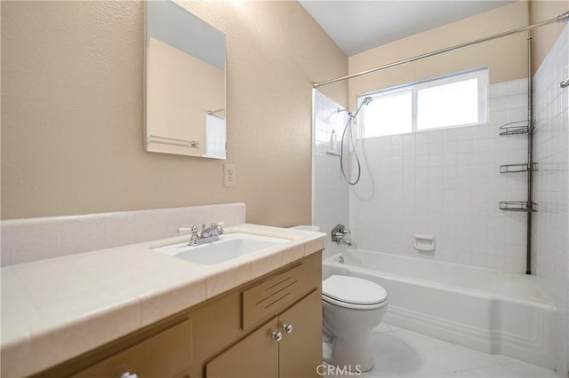 bathroom featuring toilet, vanity, and bathtub / shower combination