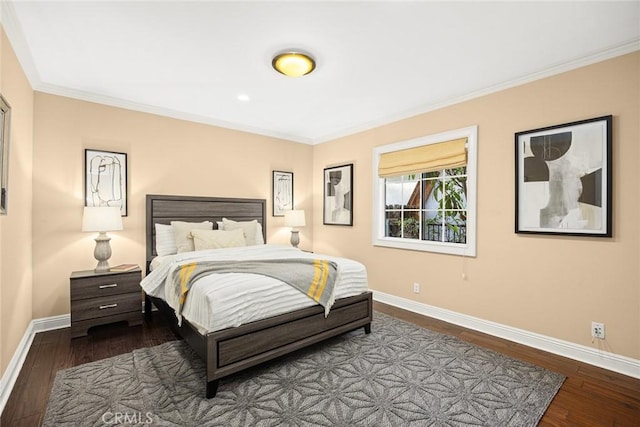 bedroom featuring baseboards, hardwood / wood-style floors, and crown molding