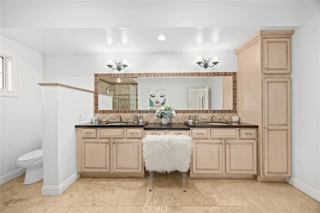 full bathroom with a sink, tiled shower, a chandelier, and double vanity