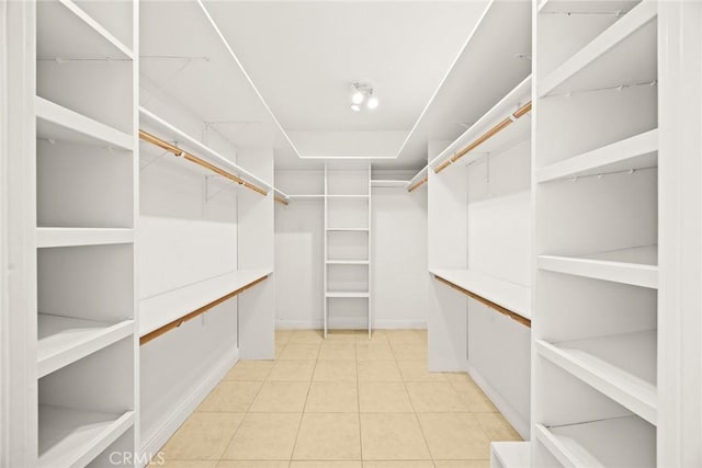 spacious closet with light tile patterned floors