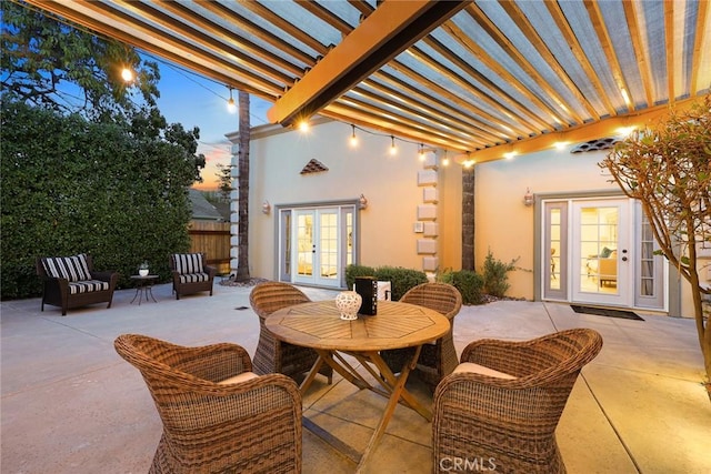 view of patio / terrace with french doors, outdoor dining area, and a pergola