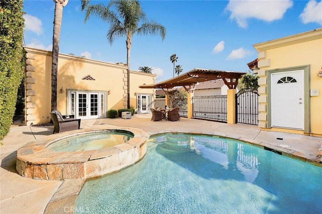 view of pool featuring fence, a pergola, a pool with connected hot tub, french doors, and a patio area