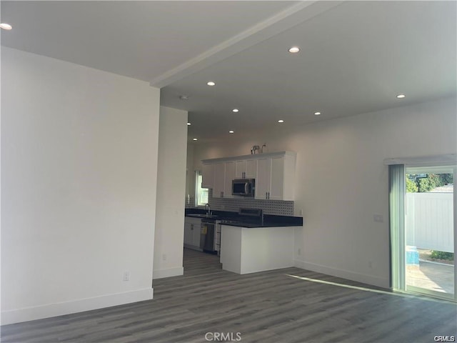 kitchen with dark countertops, tasteful backsplash, baseboards, recessed lighting, and stainless steel appliances