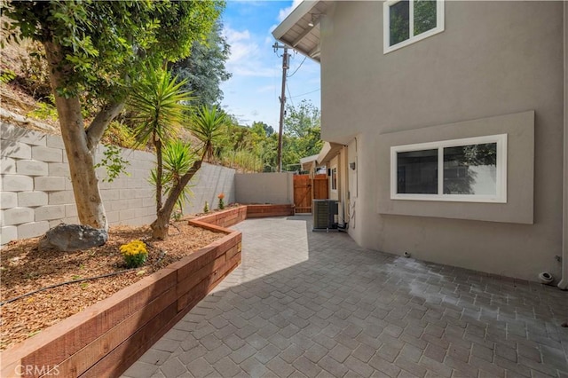 view of patio with central air condition unit and a fenced backyard