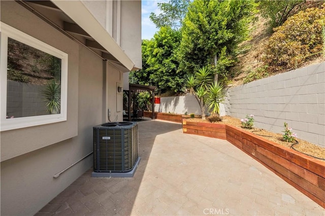 view of patio / terrace with cooling unit and a fenced backyard