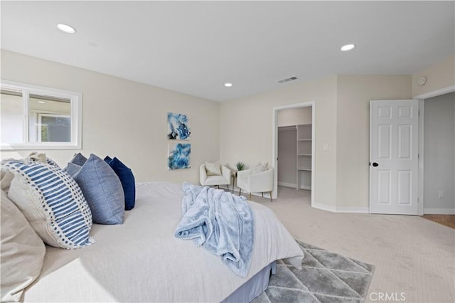 bedroom featuring visible vents, baseboards, recessed lighting, a walk in closet, and carpet flooring