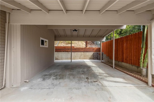 view of patio / terrace with a carport and fence