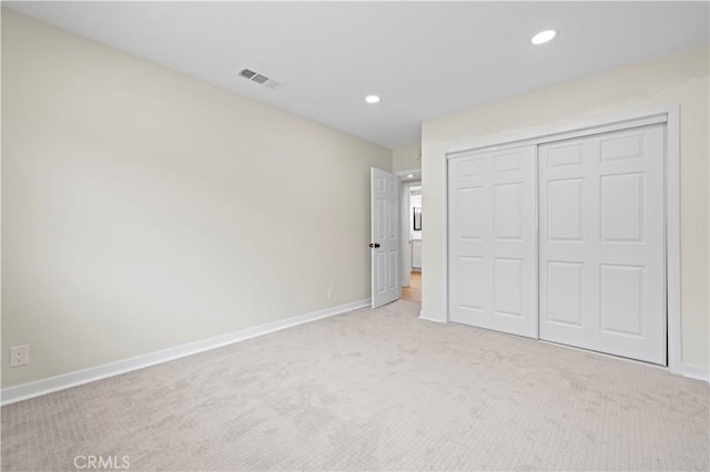 unfurnished bedroom featuring recessed lighting, visible vents, light colored carpet, and baseboards