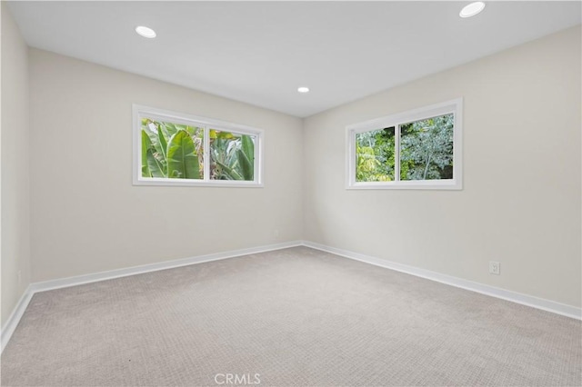 carpeted spare room with recessed lighting and baseboards