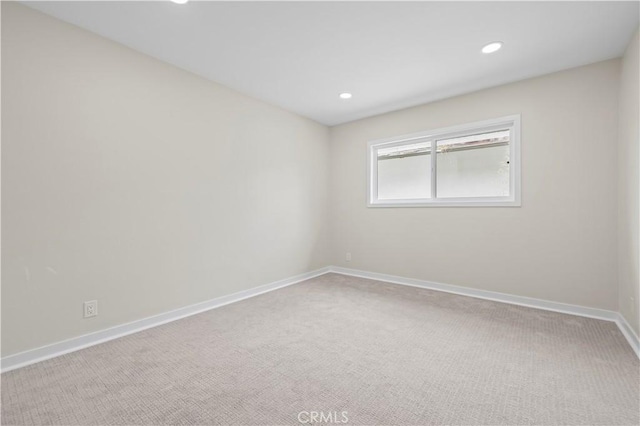 carpeted spare room with recessed lighting and baseboards