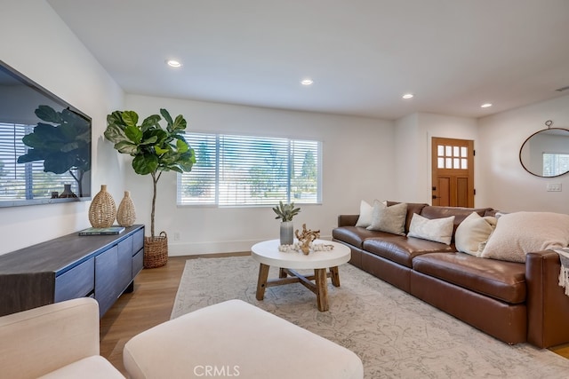 living area featuring visible vents, recessed lighting, baseboards, and wood finished floors