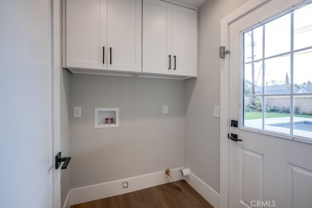 laundry area with washer hookup, dark wood-style floors, cabinet space, baseboards, and gas dryer hookup