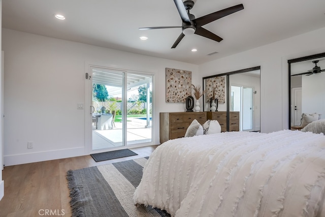 bedroom with wood finished floors, visible vents, baseboards, recessed lighting, and access to outside