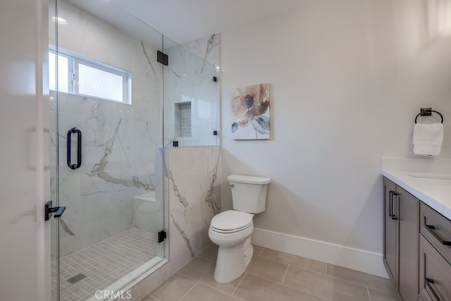 full bathroom featuring vanity, toilet, baseboards, and a marble finish shower