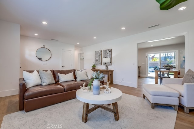 living area featuring recessed lighting, visible vents, and light wood finished floors