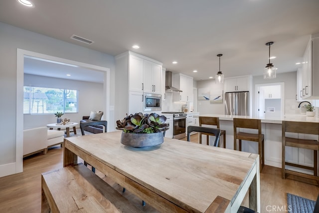 dining area featuring visible vents, recessed lighting, and light wood-type flooring