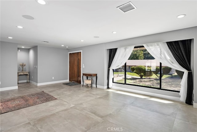 interior space featuring recessed lighting, visible vents, baseboards, and concrete flooring