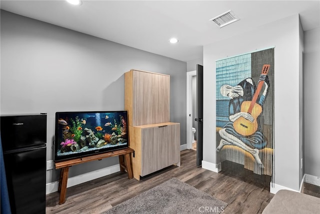 interior space with recessed lighting, visible vents, baseboards, and wood finished floors