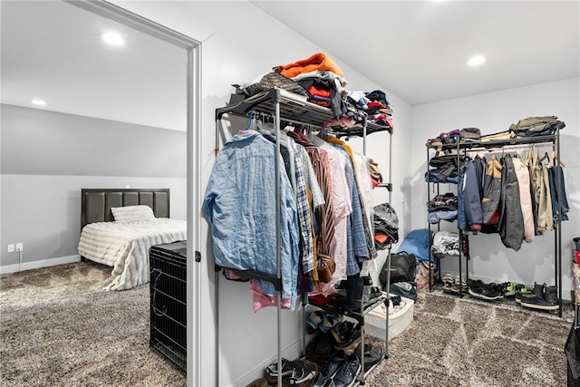 walk in closet featuring carpet flooring and vaulted ceiling