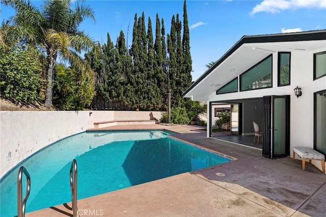 view of swimming pool with a fenced in pool and a patio