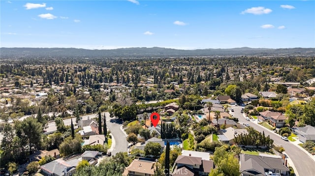 drone / aerial view featuring a residential view and a mountain view