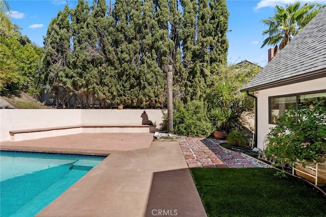 view of pool with a fenced in pool, a patio, and fence