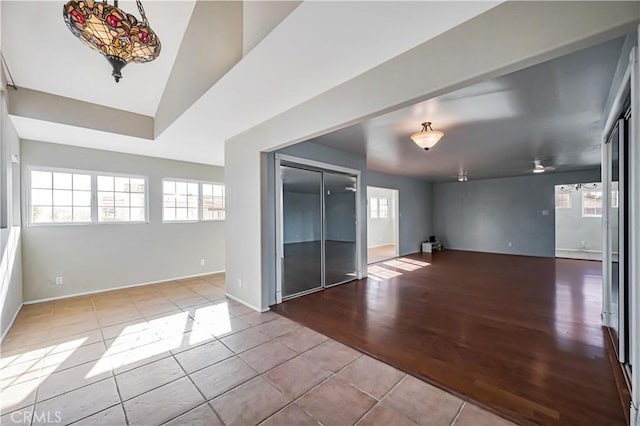 spare room featuring tile patterned flooring and baseboards