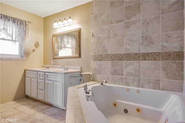 bathroom featuring tile patterned flooring, a tub with jets, double vanity, and a sink