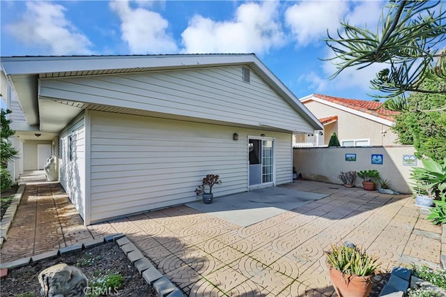 back of house featuring a patio and fence