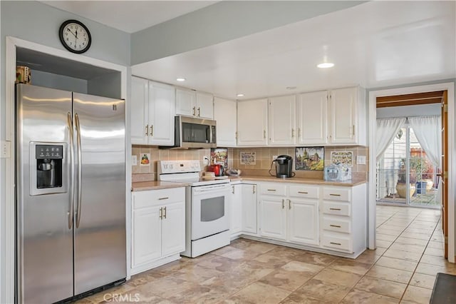 kitchen featuring stainless steel appliances, decorative backsplash, light countertops, and white cabinetry