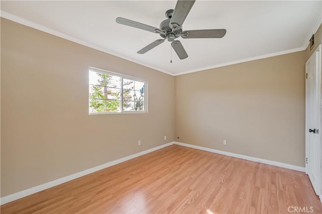 spare room with ceiling fan, light wood-style flooring, baseboards, and ornamental molding