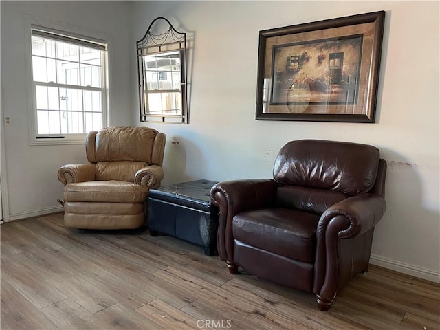 living area with wood finished floors and baseboards