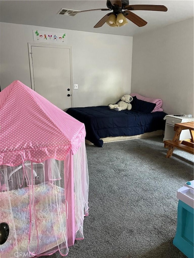 carpeted bedroom with visible vents and a ceiling fan