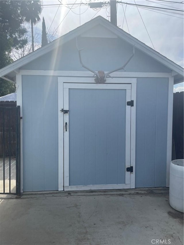 view of shed with fence