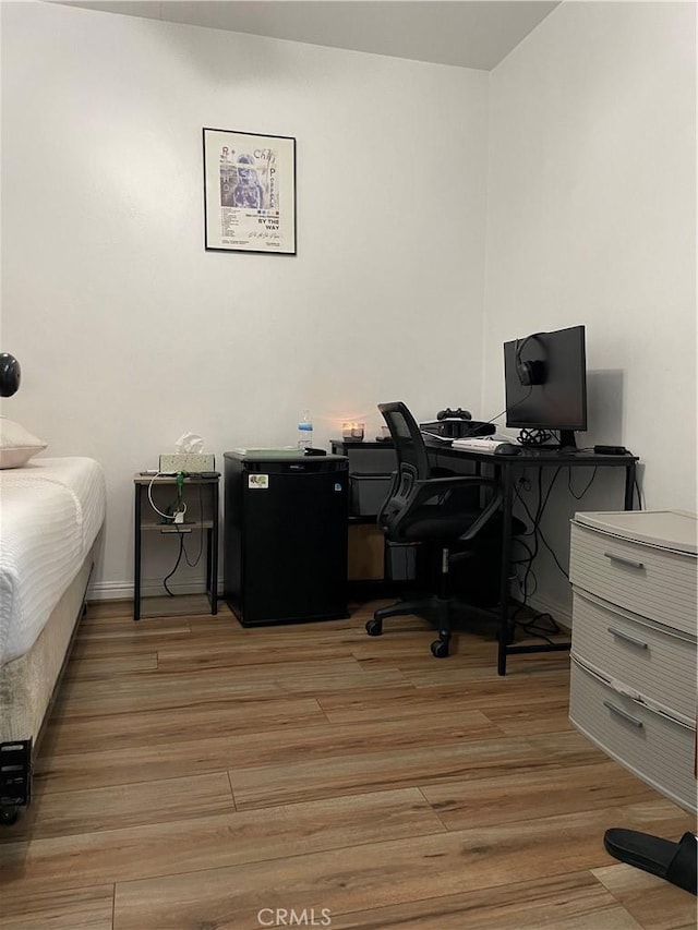 interior space with baseboards and light wood-style floors
