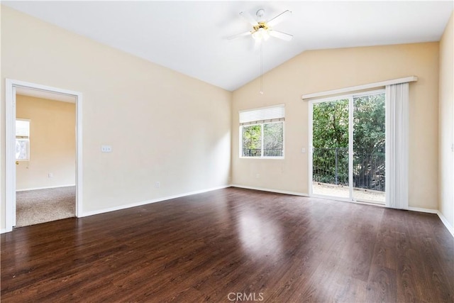 spare room featuring lofted ceiling, baseboards, dark wood-style flooring, and ceiling fan