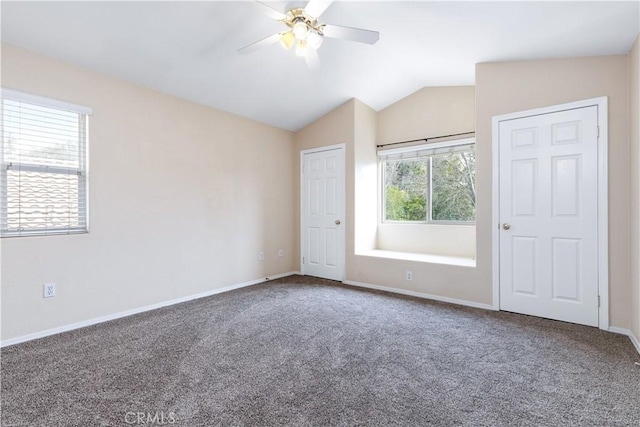 unfurnished bedroom with baseboards, a ceiling fan, carpet flooring, and vaulted ceiling