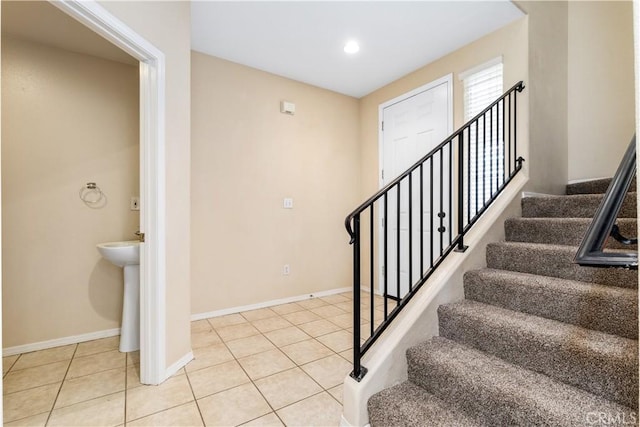 stairs featuring tile patterned flooring, recessed lighting, and baseboards