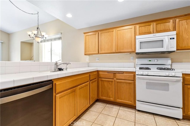 kitchen with tile countertops, white appliances, a peninsula, light tile patterned flooring, and hanging light fixtures