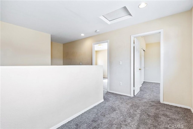 carpeted empty room with attic access, recessed lighting, and baseboards