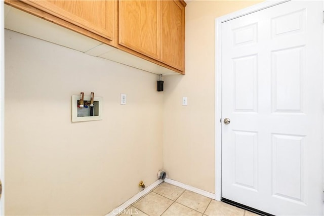 laundry room with light tile patterned floors, baseboards, cabinet space, and washer hookup