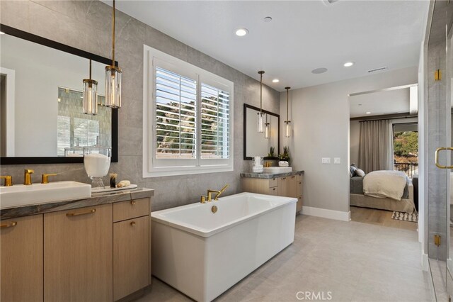 9522 N Andora Ave, Chatsworth, CA 91311 - full bathroom with visible vents, a sink, a soaking tub, connected bathroom, and two vanities