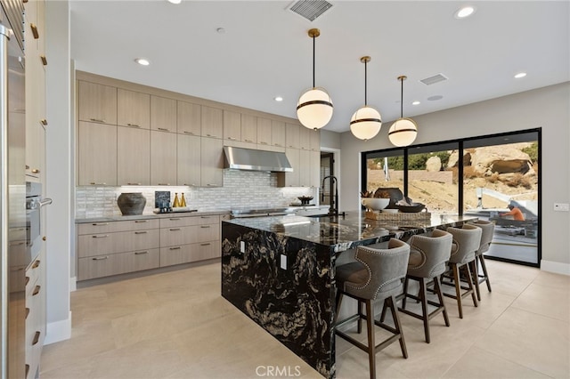 9522 N Andora Ave, Chatsworth, CA 91311 - kitchen featuring visible vents, modern cabinets, a sink, under cabinet range hood, and backsplash